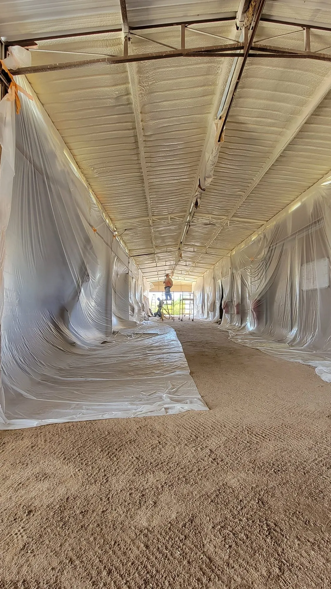 Spray foam and insulation work in an attic assembly