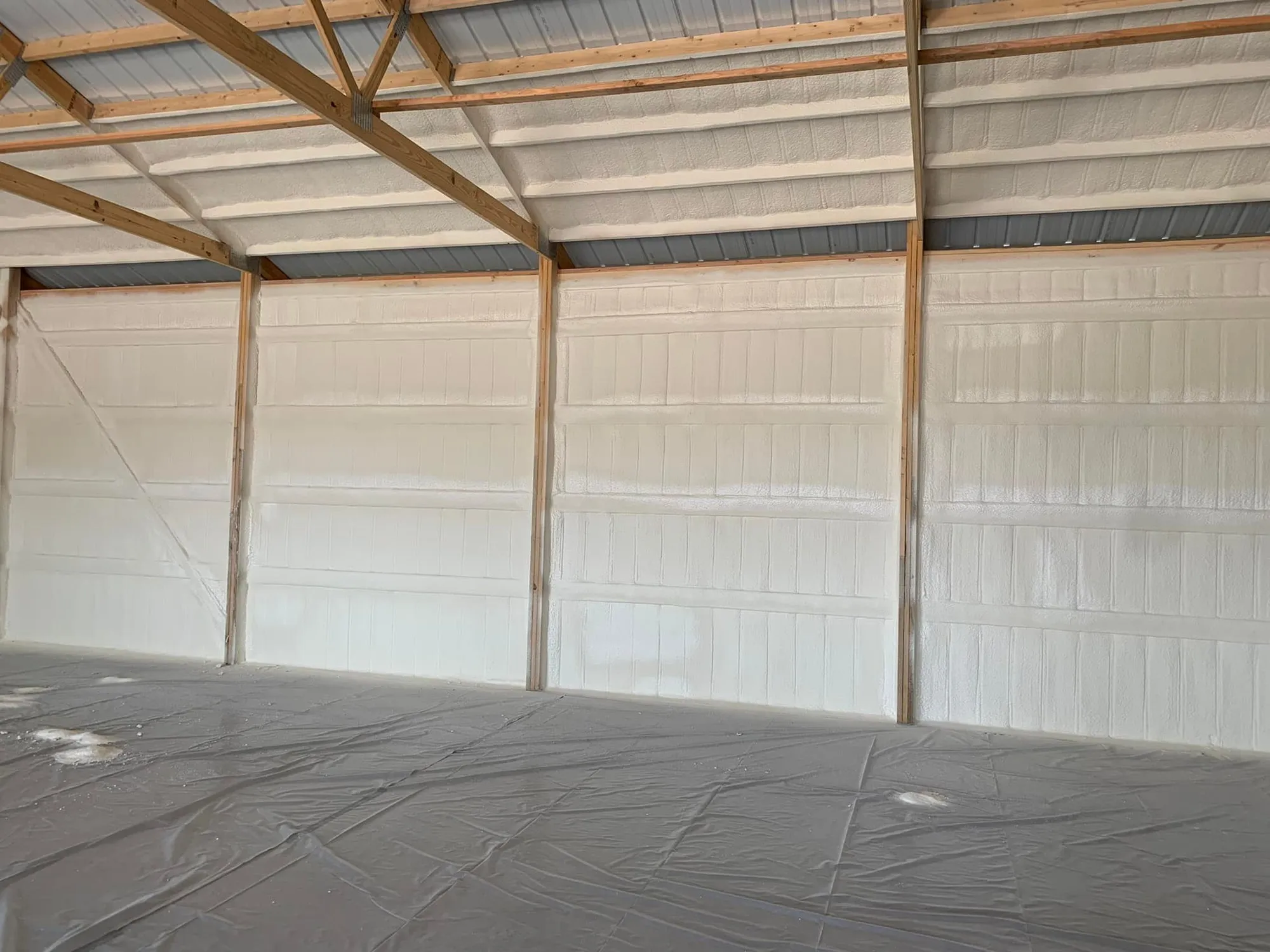 Spray foam installer using professional application equipment